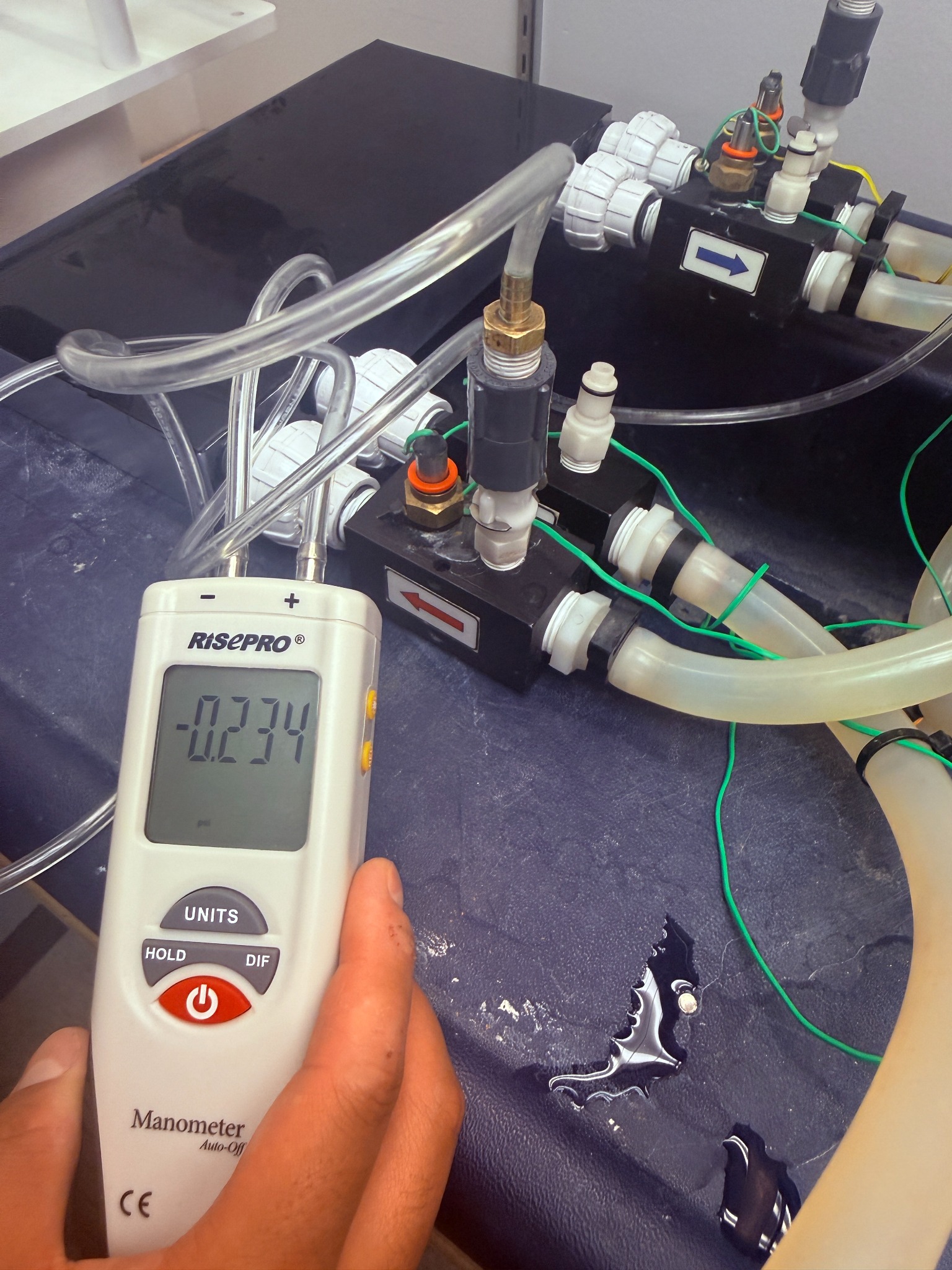 Handheld manometer connected to the custom heat exchanger