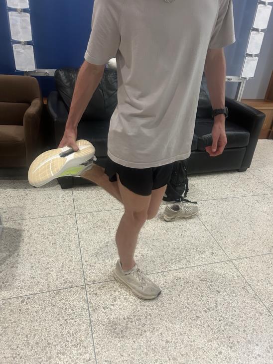 Athlete wearing and testing the recovery shoe while standing